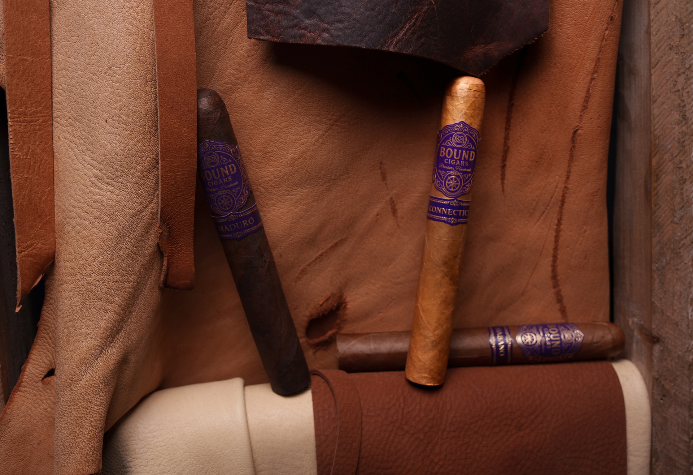 Three Bound cigars laid on leather