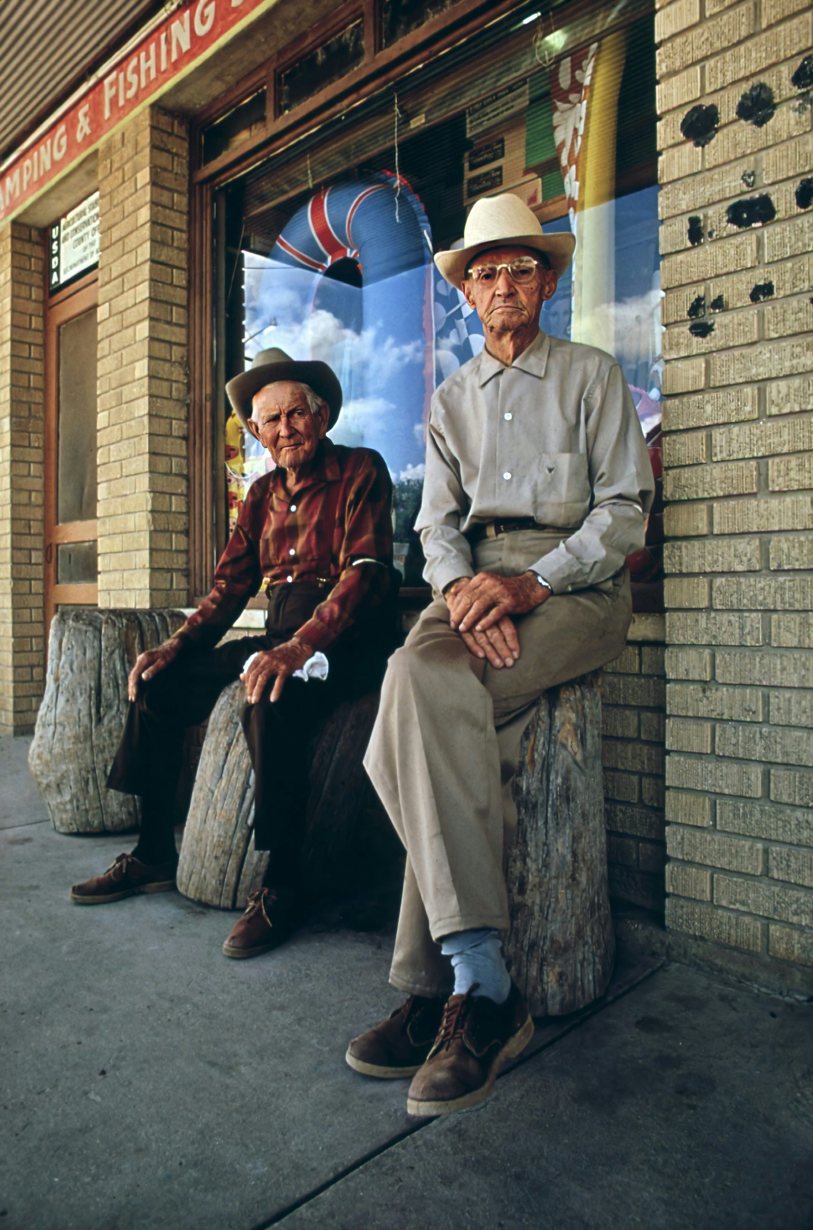 Two older men sitting together on a bench