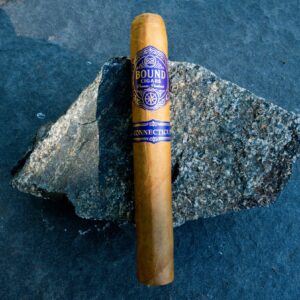Northbound Connecticut cigar resting on a granite stone
