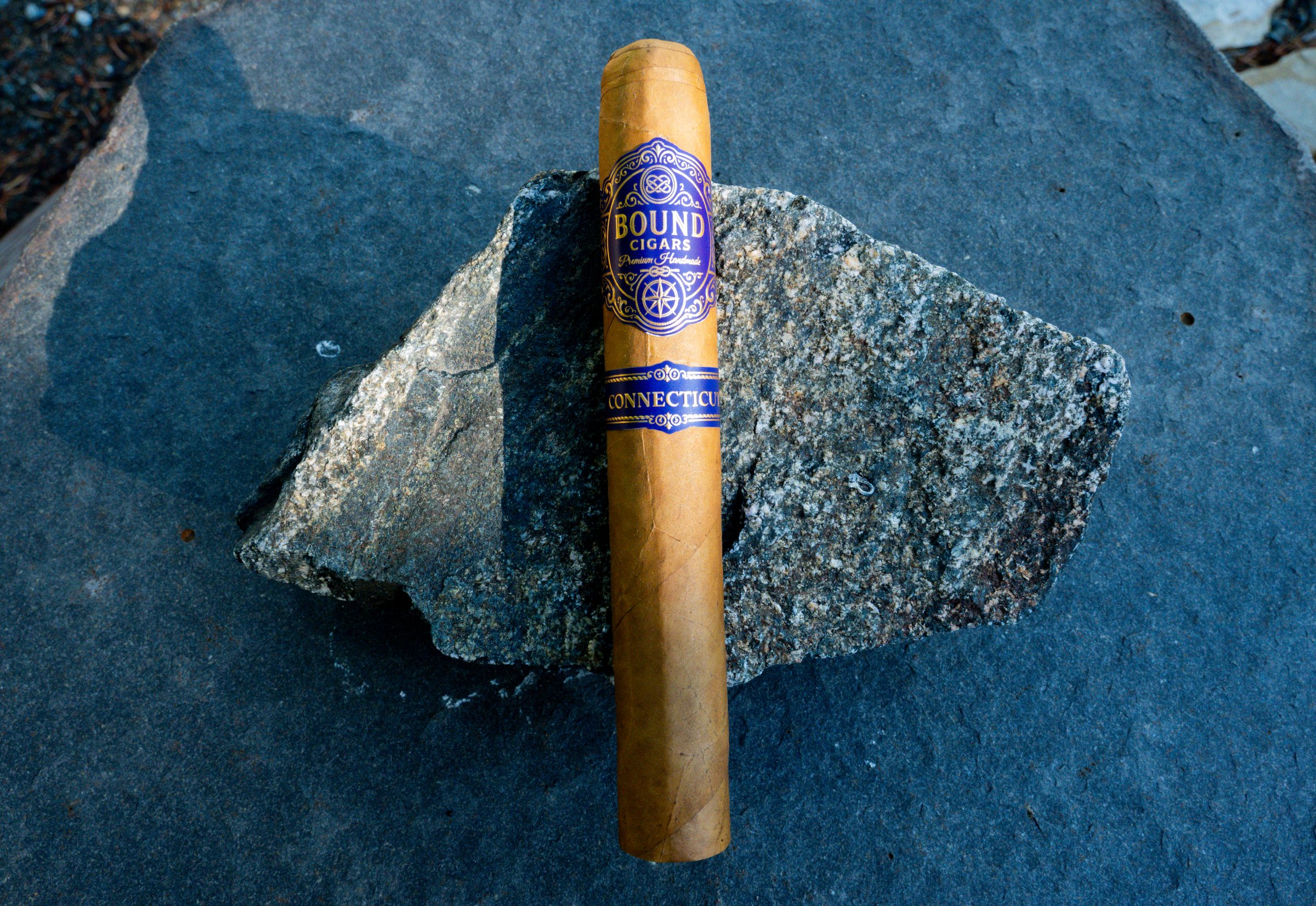 Northbound Connecticut cigar resting on a granite stone