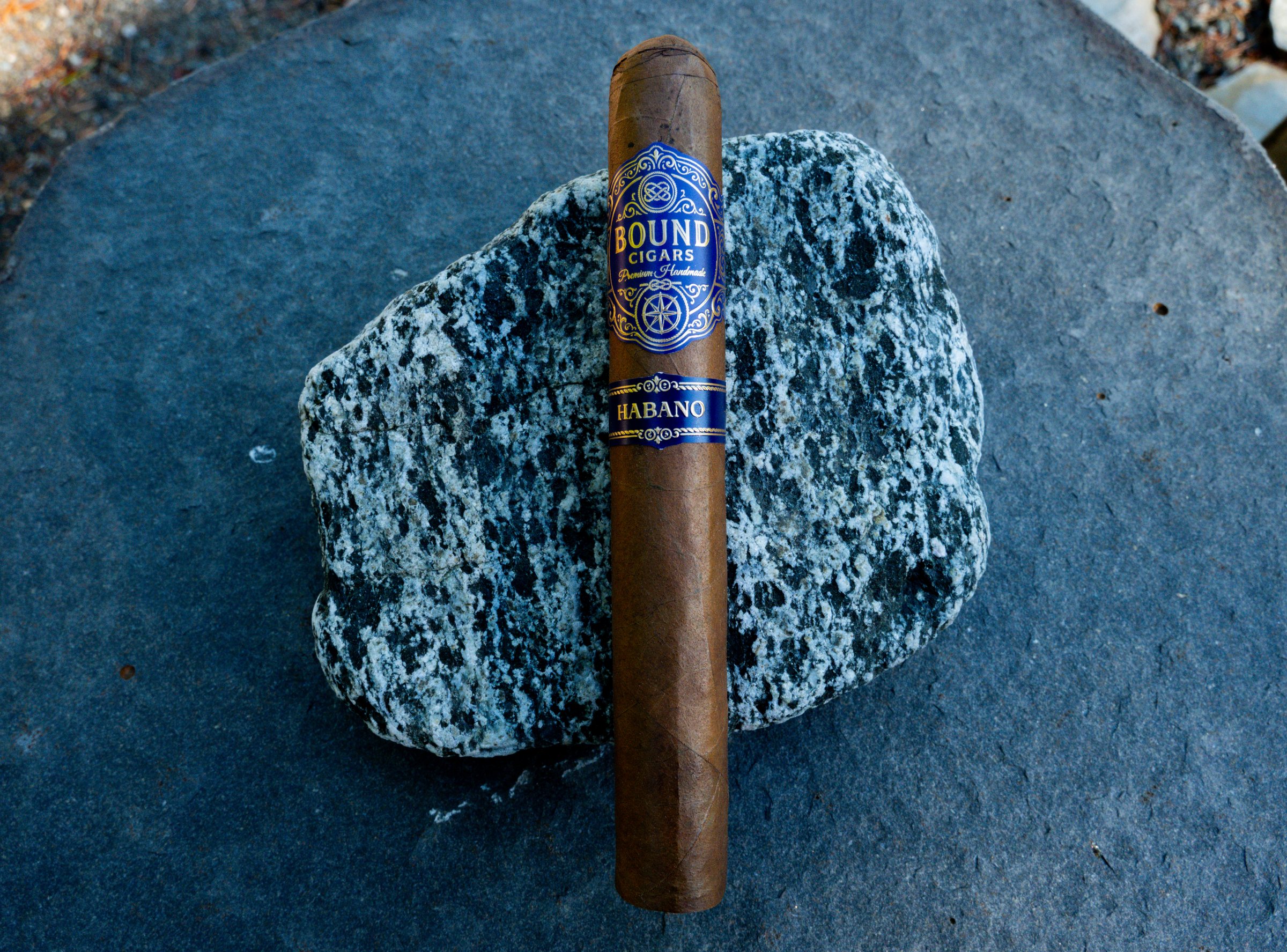 Northbound Habano cigar resting on a speckled stone