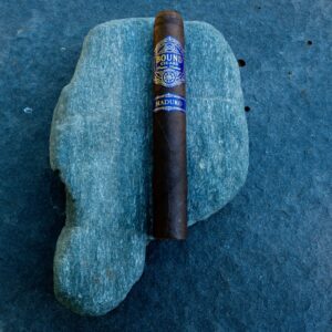 Northbound Maduro cigar resting on a green stone